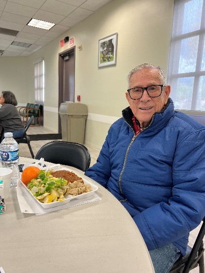 A person sitting at a table with food